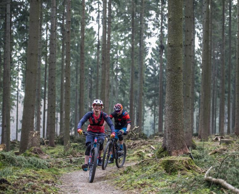 A couple go mountain biking in Silkeborg, Jutland, Denmark