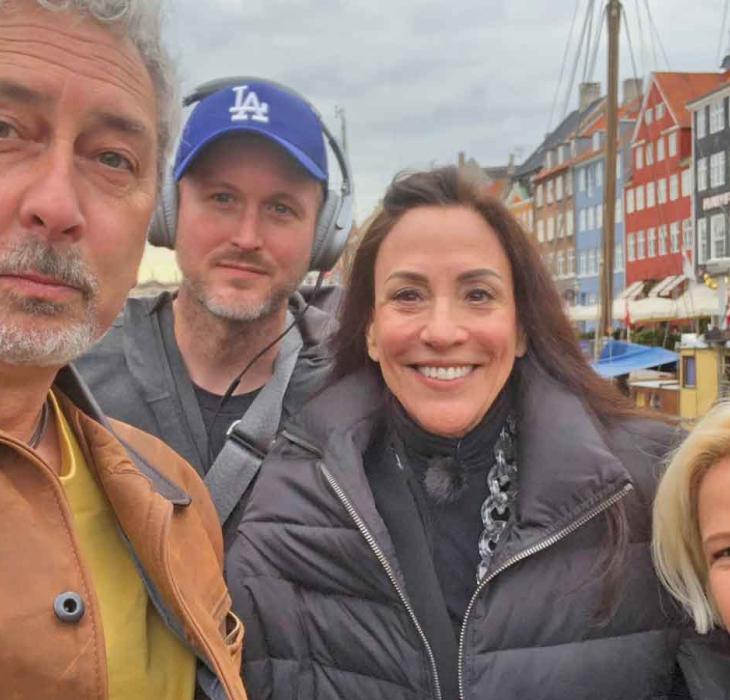 The team from America By Design pose in front of the coloured houses of Nyhavn in the heart of Copenhagen, Denmark