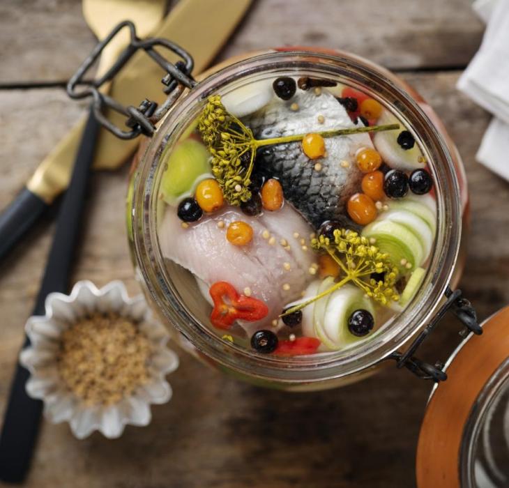 a glass jar filled with pickled herring in Denmark